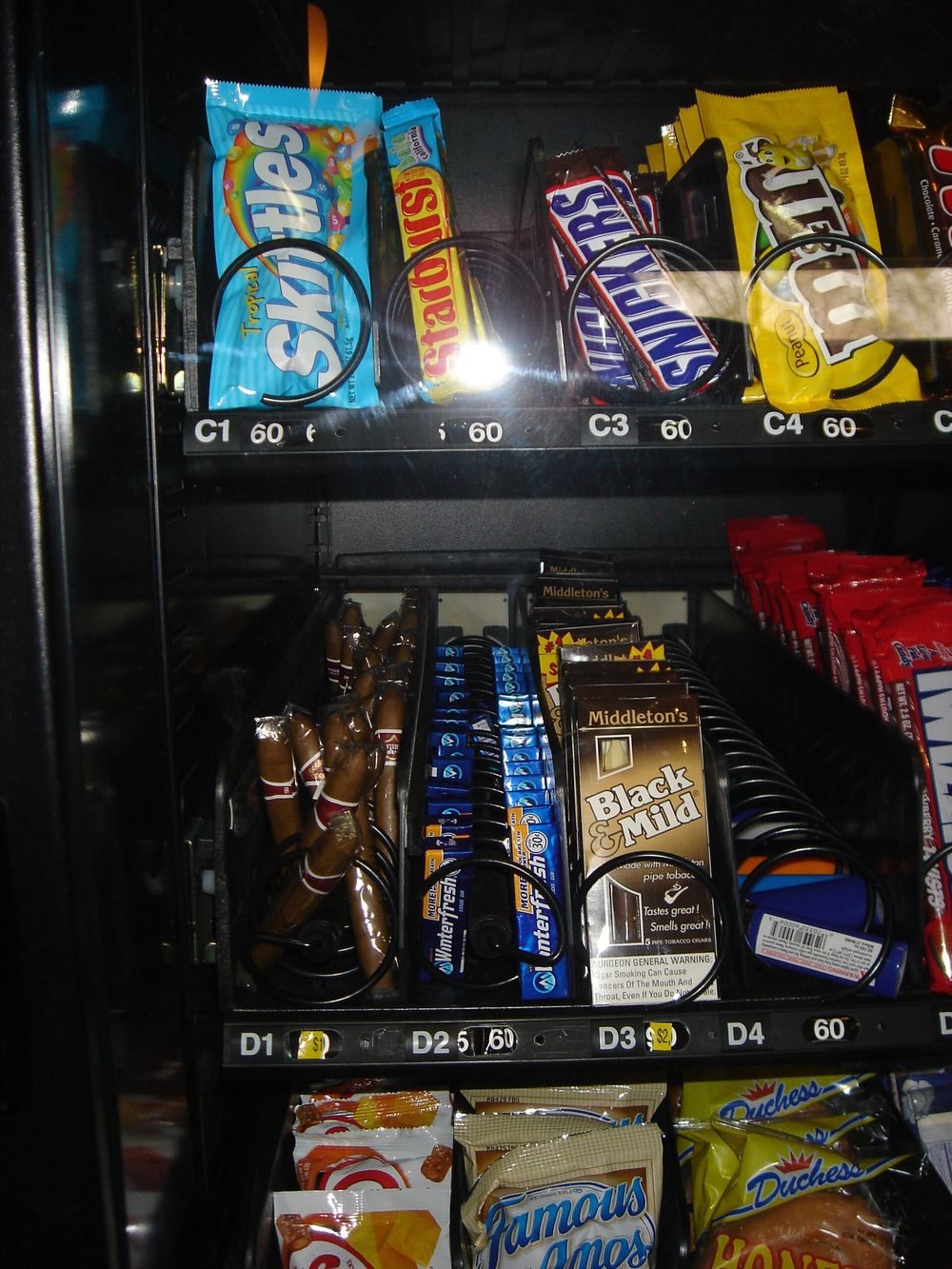 Close-up of snacks loaded in vending machine coils
